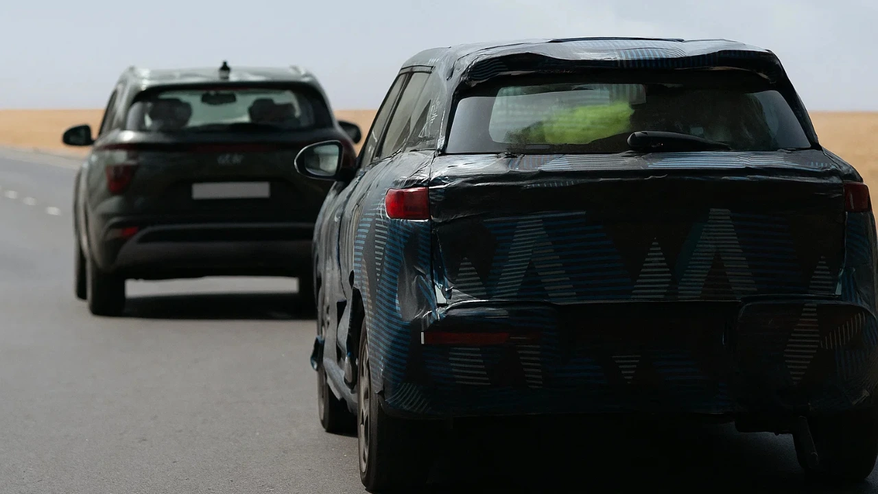 BYD Atto 2 EV SUV test mule heavily camouflaged during road testing in India, with a Hyundai Creta following behind.
