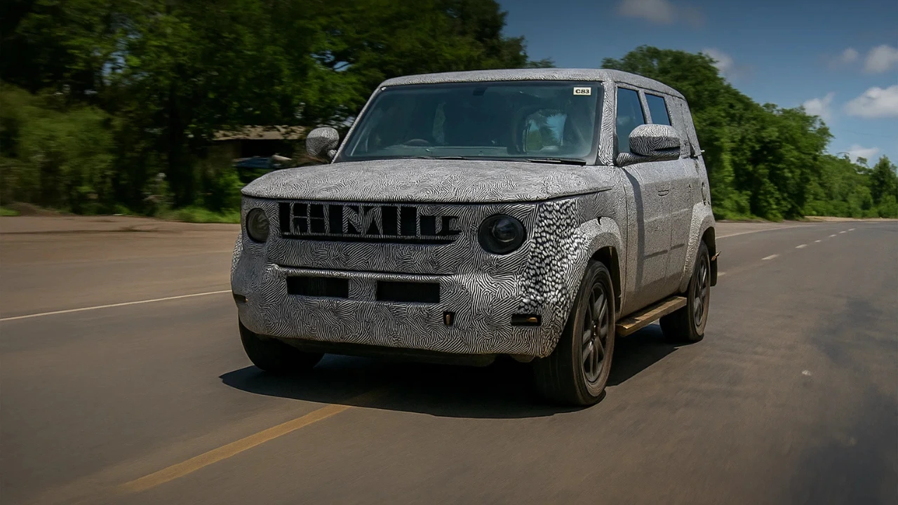 Mahindra Bolero Neo Facelift test mule camouflaged on road, showing updated front grille and headlights.