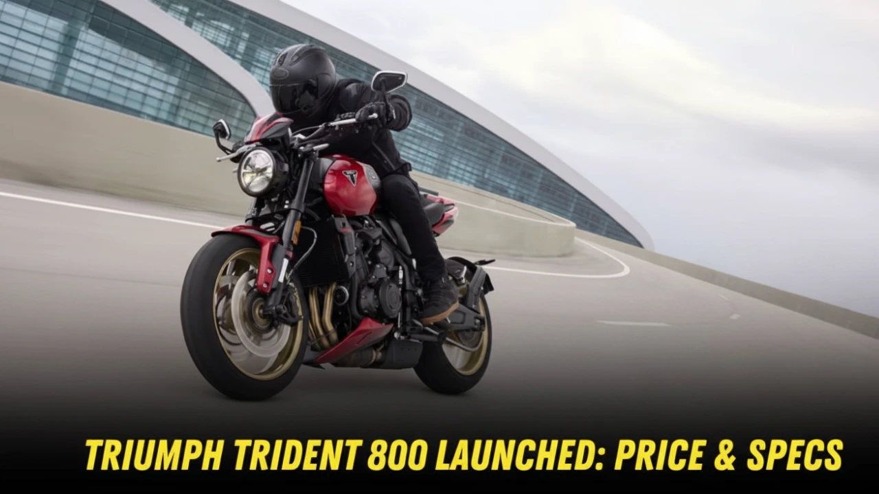 Red Triumph Trident 800 motorcycle being ridden on a modern track with a distinctive architectural building in the background. Bold yellow text at the bottom reads 'Triumph Trident 800 Launched: Price & Specs'.