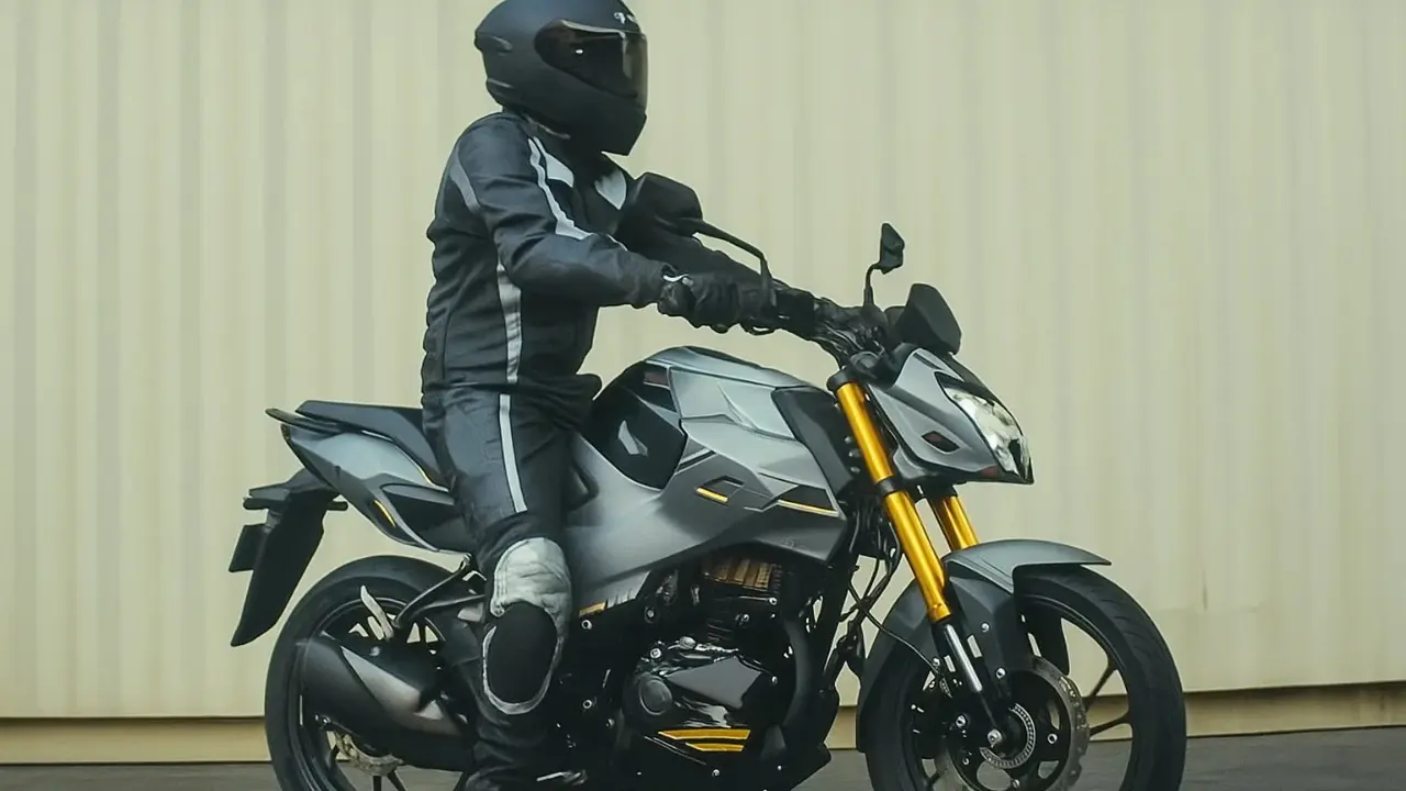 Hero Xtreme 160R 4V launch grey motorcycle side view with USD forks and rider in black riding gear