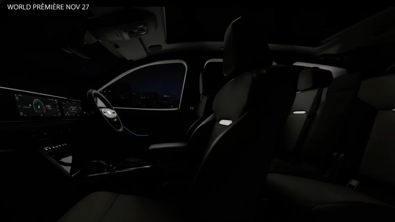 Dark interior view of the Mahindra XEV 9S 7-seater electric SUV, showing the triple-screen digital cockpit, ambient blue lighting, and panoramic sunroof at night.
